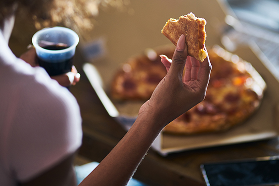 Person holding pizza