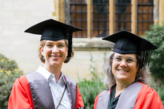 Jennifer Doudna and Andrea Ghez in academic robes.