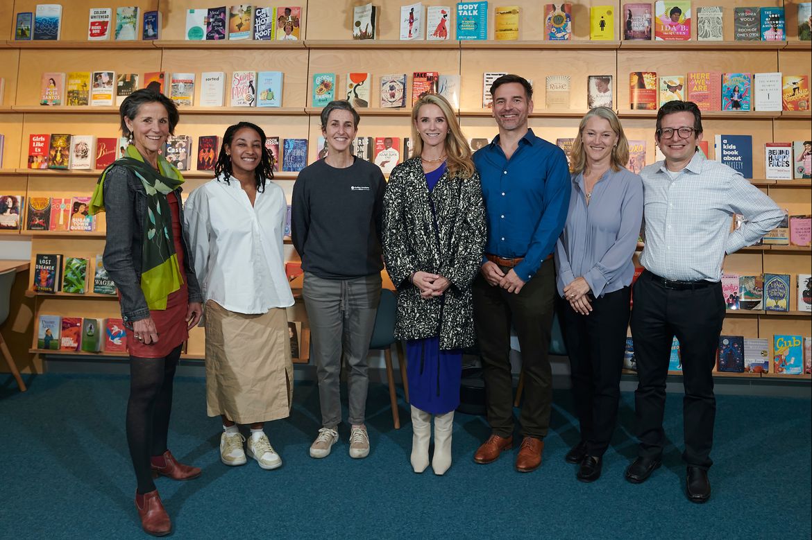 Image of key leaders at the Geffen Academy standing in a room with a wall of books in the background.