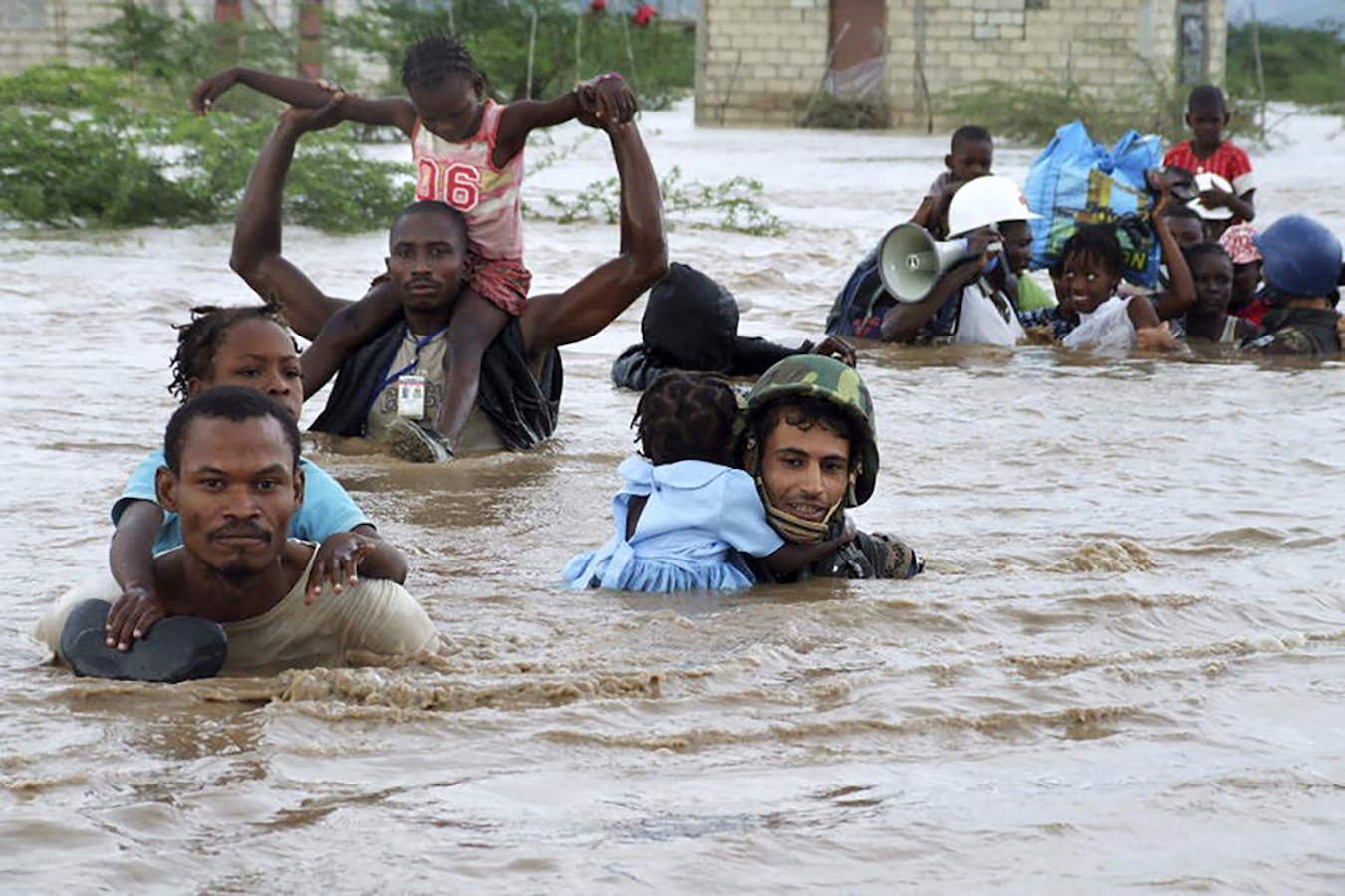 Members of the Jordanian battalion of the United Nations Stabilization Mission in Haiti carry children through flood waters after a rescue from an orphanage destroyed by Hurricane Ike.