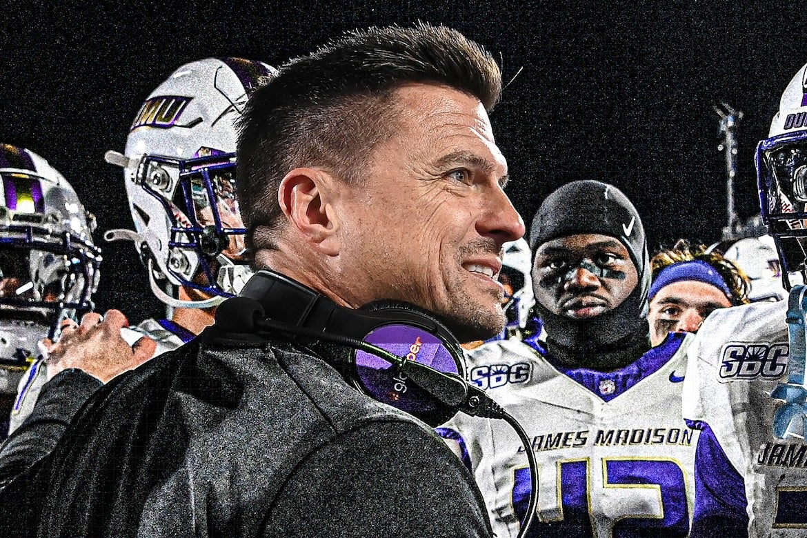 Bob Chesney, UCLA’s new head football couch surrounded by players from James Madison University