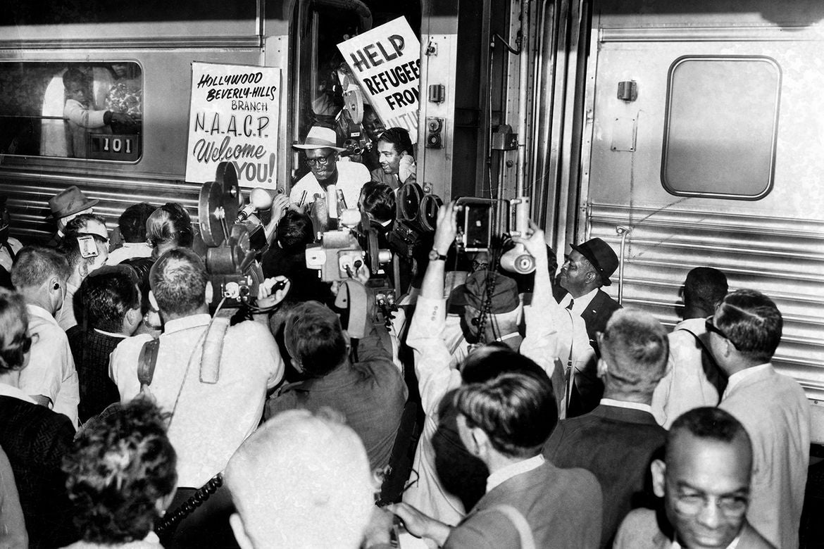 Black-and-white historical photo: Freedom Train passengers are welcomed by a crowd that includes the Hollywood/Beverly Hills branch of the NAACP.