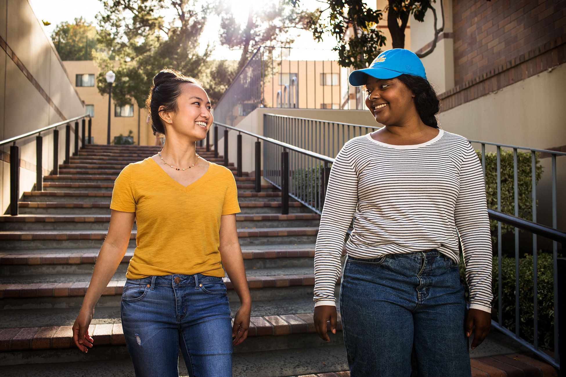Two female students walk down a flight of stairs near the residence halls on UCLA’s North campus.