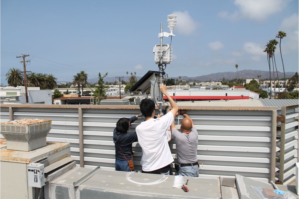 Faculty from the UCLA Fielding School of Public Health install an air quality sensor atop a building in Santa Monica
