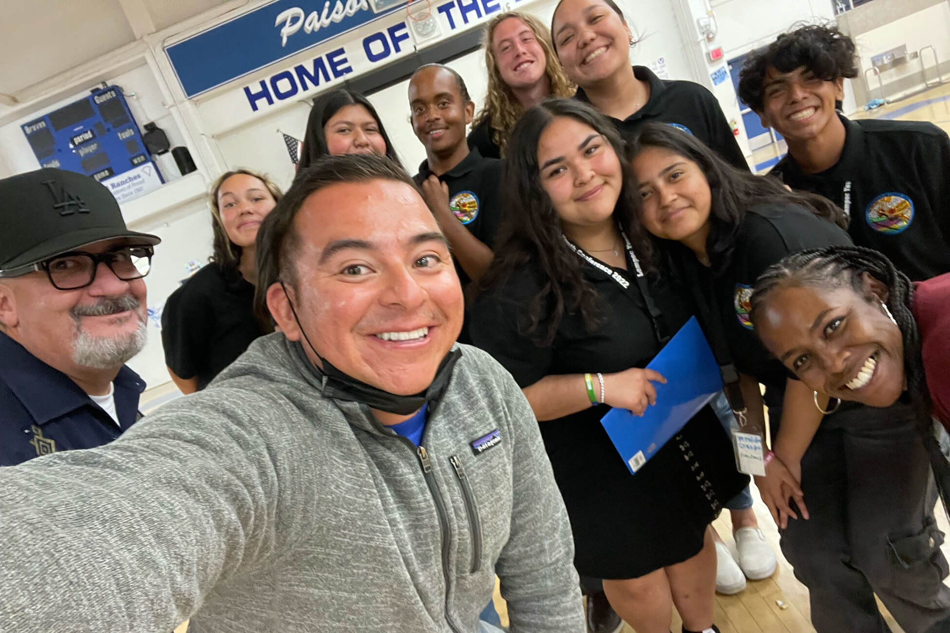 Group of staff members and students pose for a selfie at a school in Lompoc