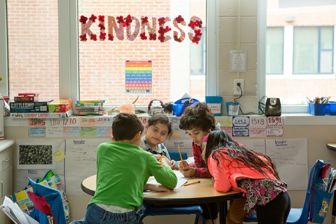 Students studying at a desk in a classroom