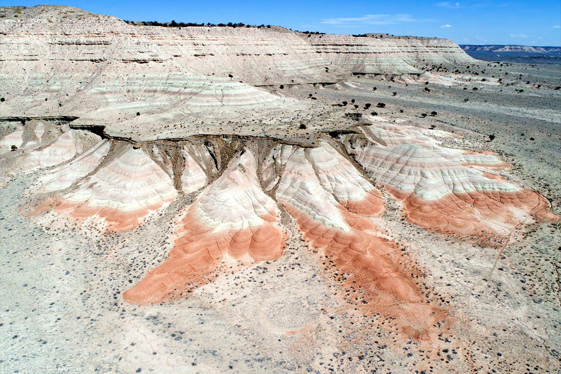 Dark red and green mudstone beds with tan sand-dominated layers