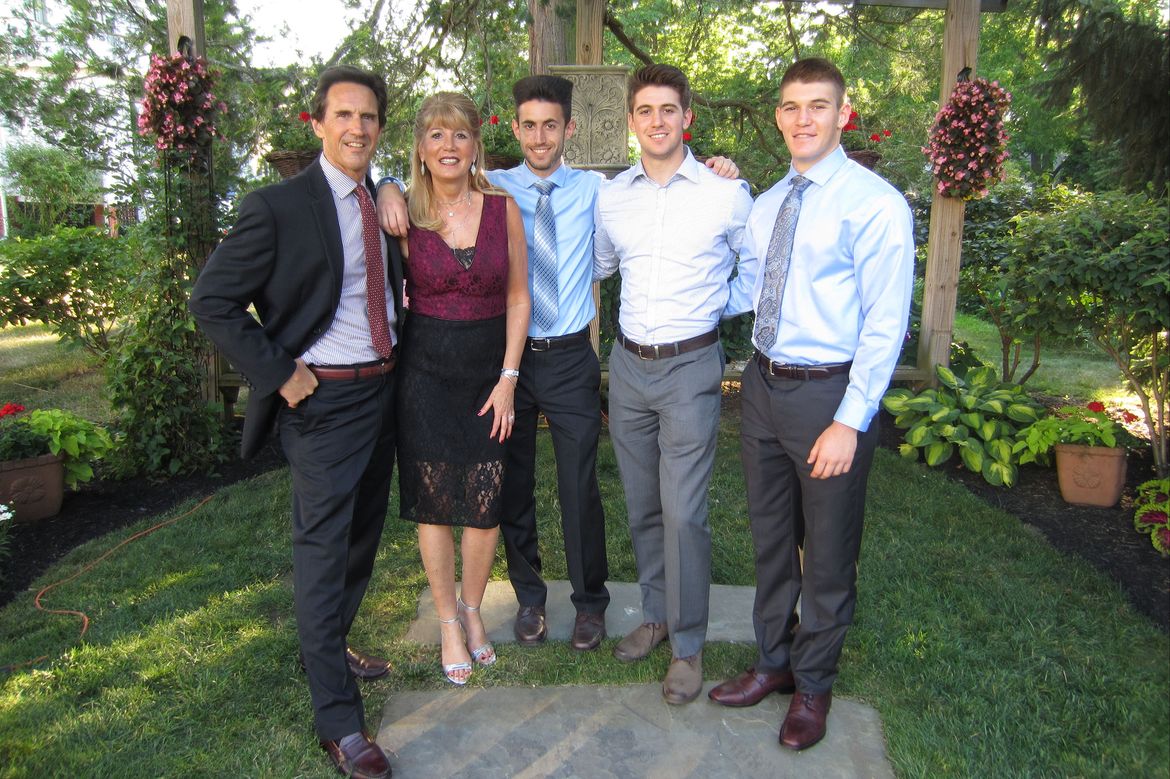 Nelson family, from left: Allen, Rose, Brandon, Trent and Justin, all dressed up posing outdoors for a group photo