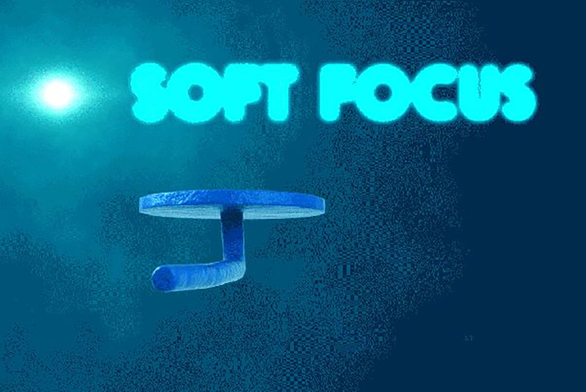 Blue disc-shaped object with post and words SOFT FOCUS on a blue background