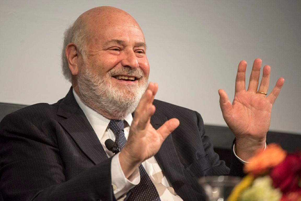 Close-up portrait of Rob Reiner, with hands raised, speaking at the LBJ Presidential Library in 2016