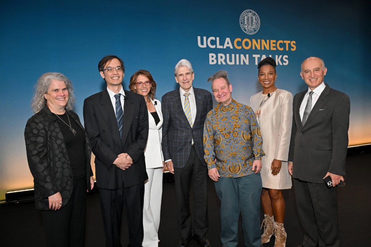 Left to right: Andrea Ghez, Terence Tao, Lynn Vavreck, Chancellor Julio Frenk, Peter Sellars, Kimberlé Crenshaw and Abbas Ardehali standing in front of UCLA Connects Bruin Talks sign