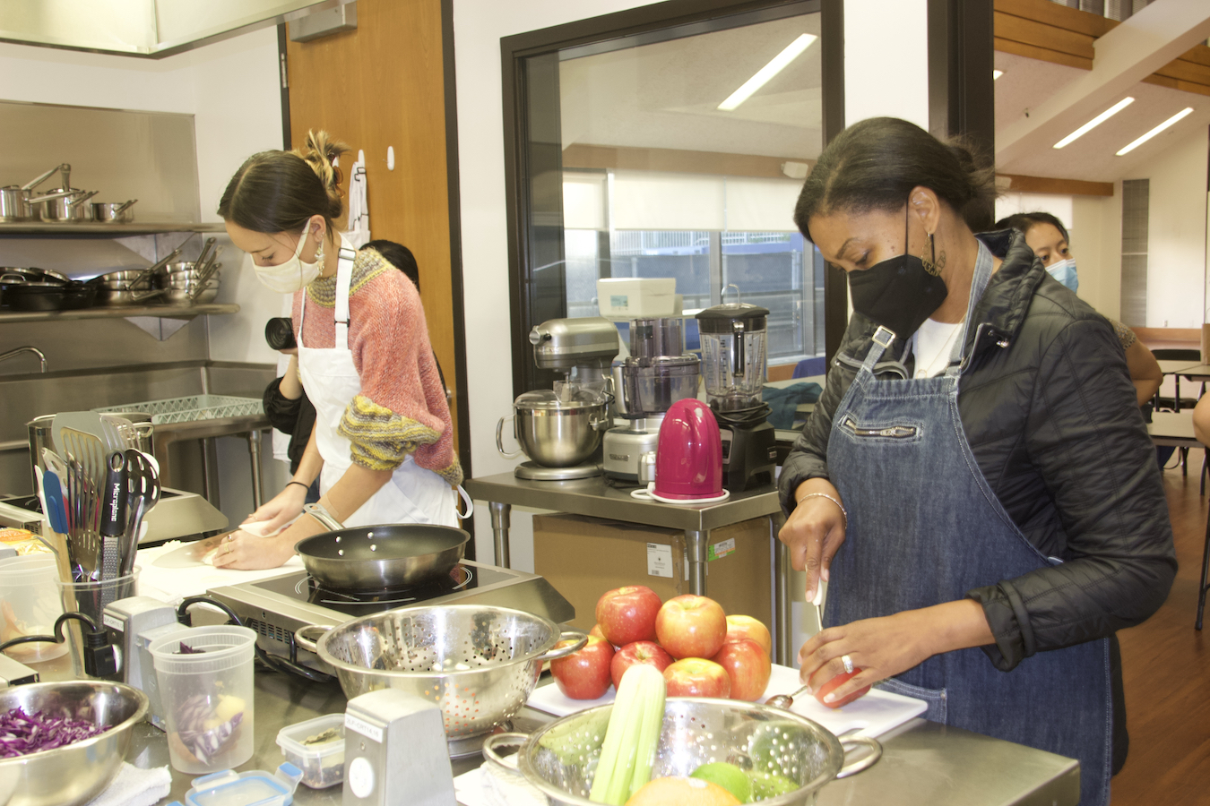 Two people preparing food in UCLA’s teaching kitchen.