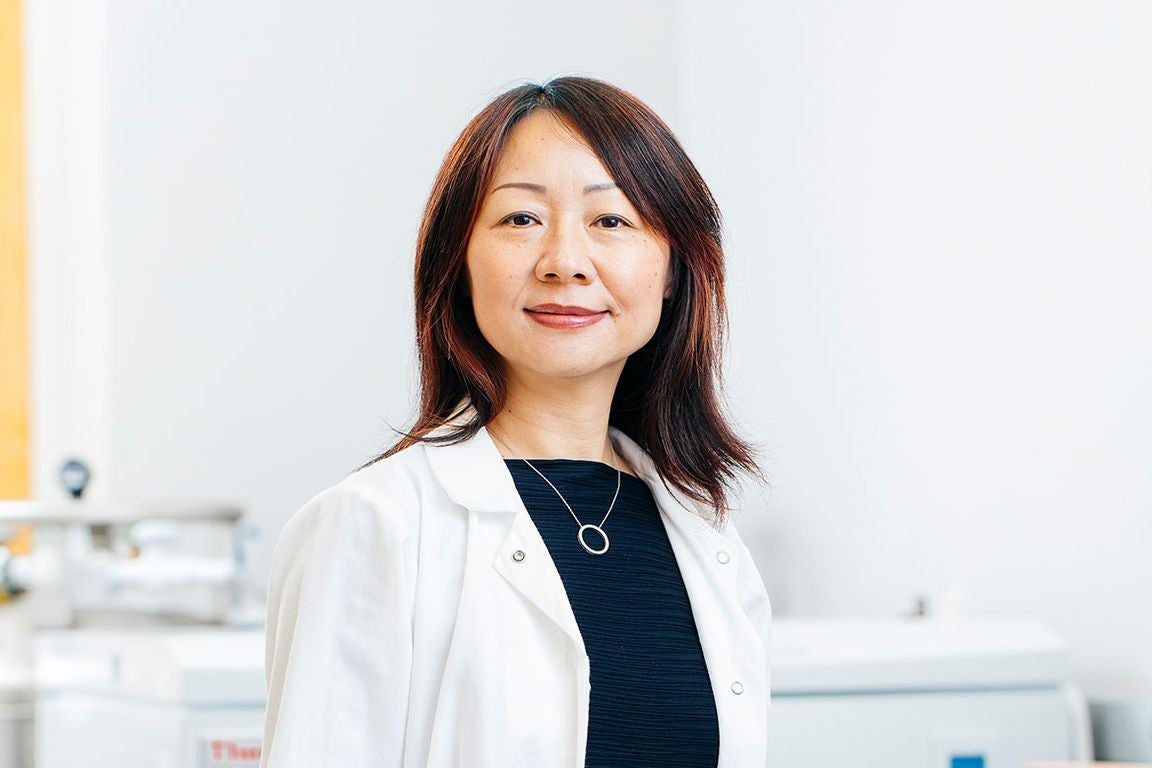 Head-and-shoulders photo of Lili Yang in dark blue top and white coat