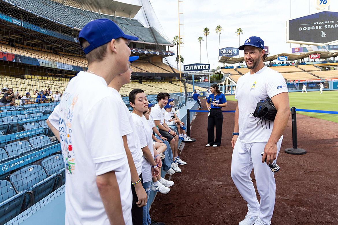 Dodgers’ pitcher Clayton Kershaw, right, visits with several pediatric cancer patients at Dodger Stadium