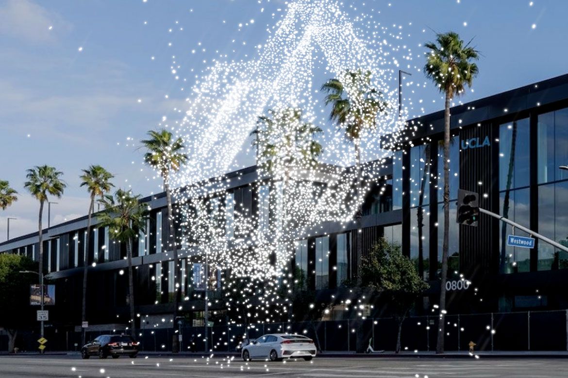 Image of building with palm trees out front and overlay of white sparkles