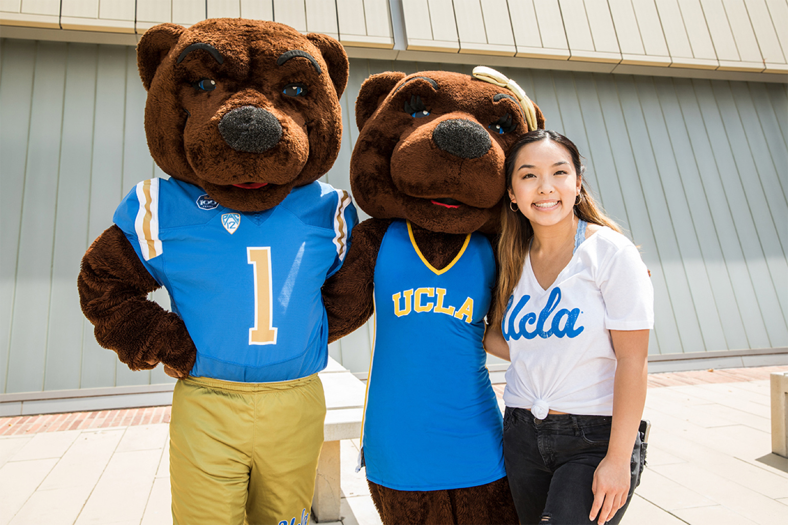 A student poses with Joe and Josie Bruin