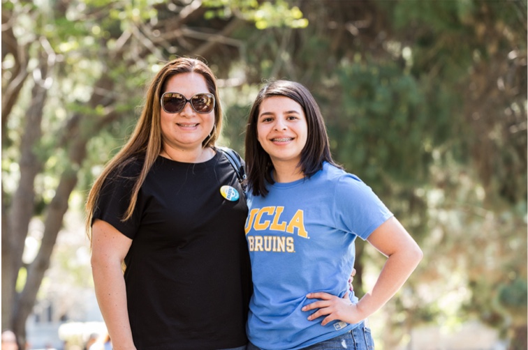 A Bruin and her mother smile together.