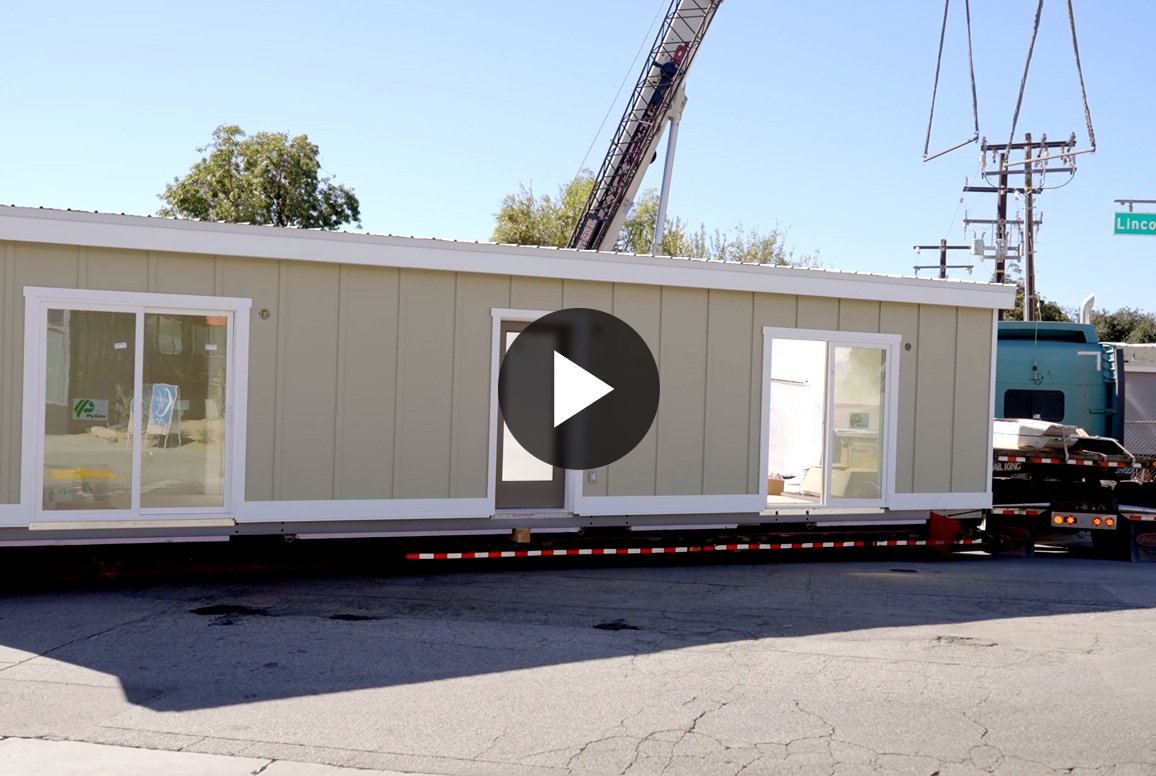 A prefabricated home loaded on a truck