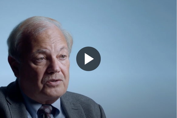 headshot of an elderly man with a play button”