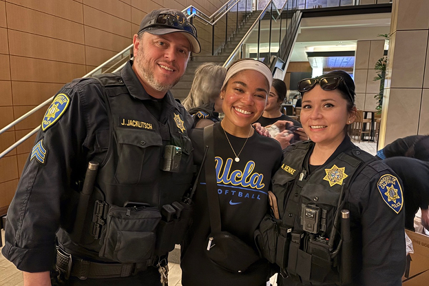 2 firefighters posing with student