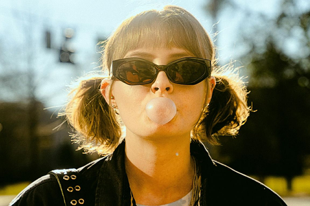 Girl blowing a giant bubble gum