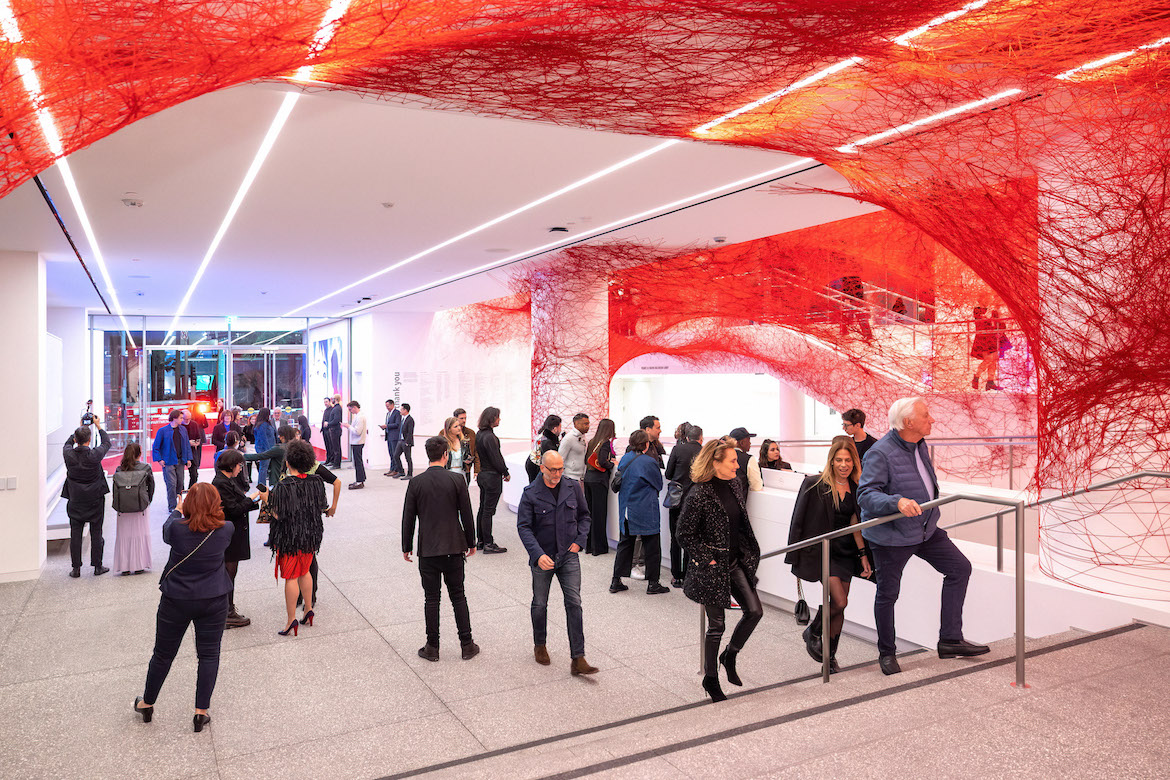 Patrons walk through the Hammer Museum's new entrance, which is filled with red threads