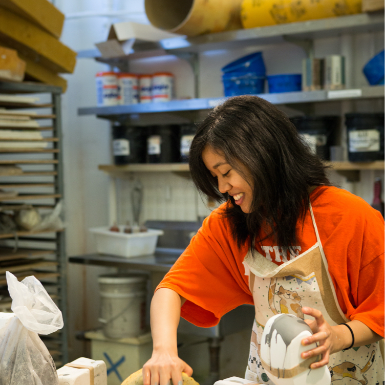 A female student works on a ceramics project.